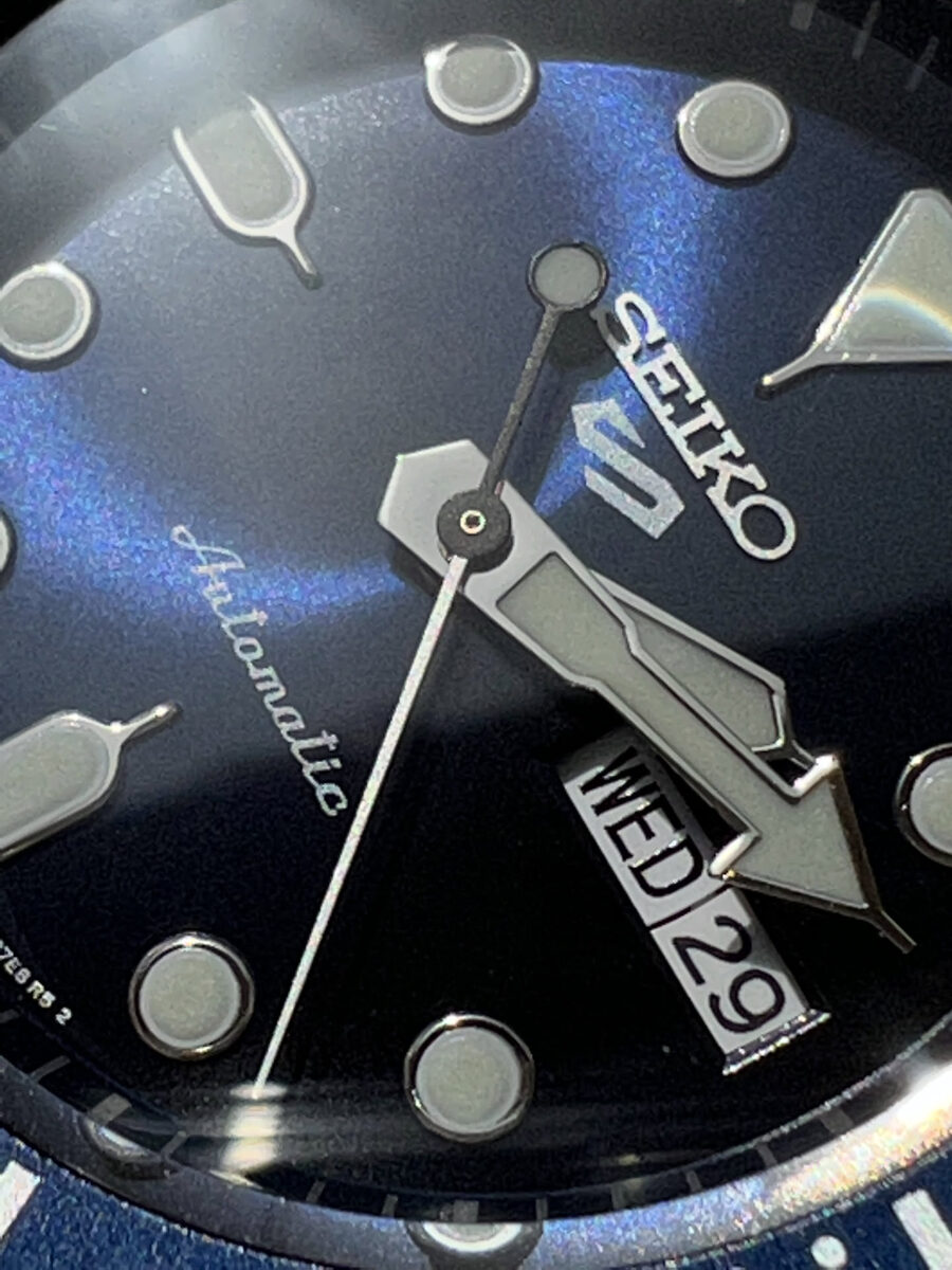 Macro shot of a blue Seiko 5 automatic dial